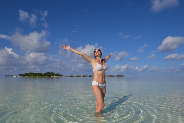 mujer joven feliz en vacaciones de verano en la hermosa playa tropical diviértete, disfruta y relájate
