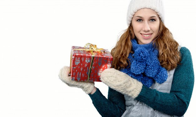 Mujer joven con un gorro de invierno con regalo