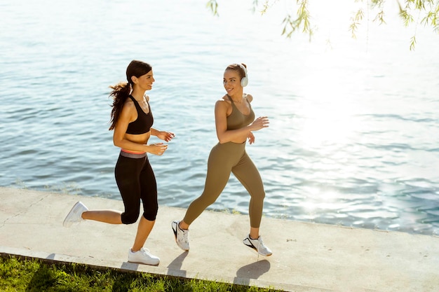 Mujer joven haciendo ejercicio corriendo por el paseo del río