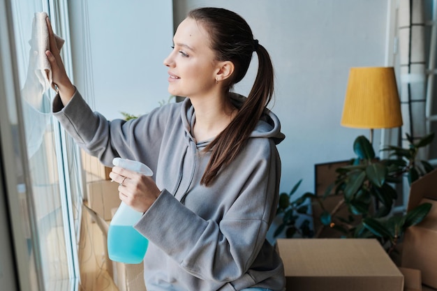 Mujer joven haciendo limpieza en casa