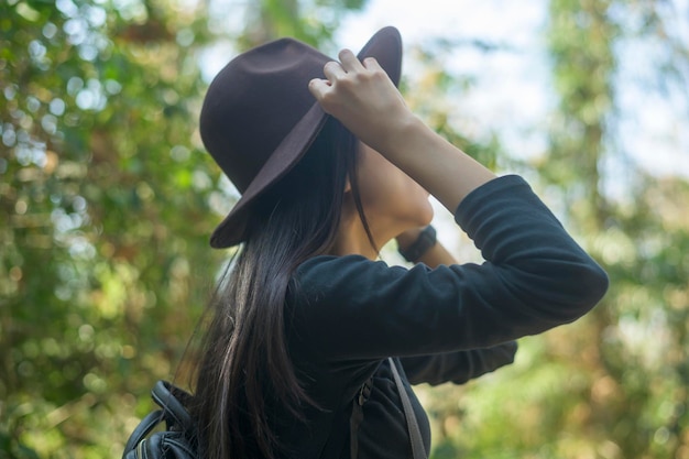 Una mujer joven haciendo senderismo y disfrutando de las vacaciones en el bosque y el concepto de viaje