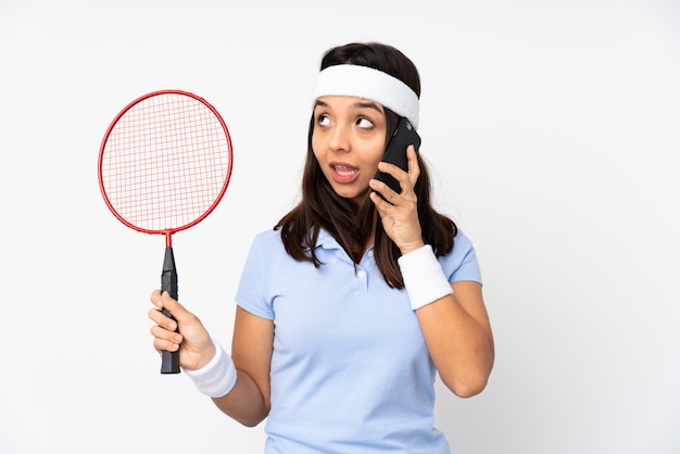 Mujer joven jugador de bádminton con café para llevar y un móvil