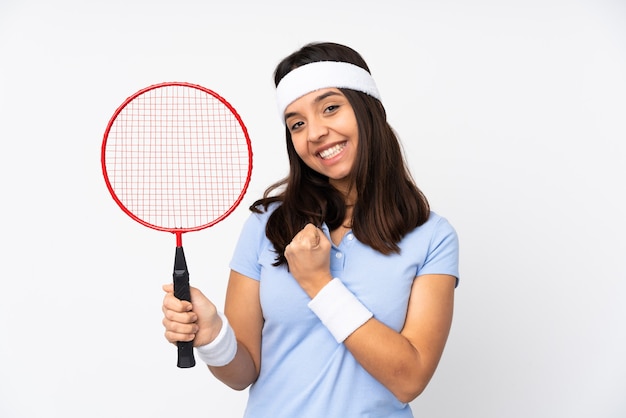 Mujer joven jugador de bádminton sobre blanco aislado celebrando una victoria