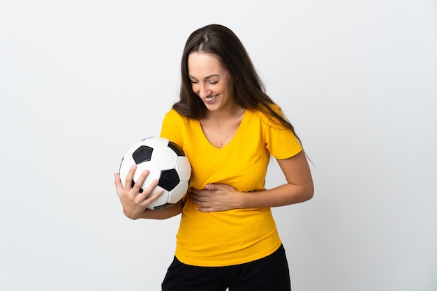 Mujer joven jugador de fútbol sobre pared blanca aislada sonriendo mucho