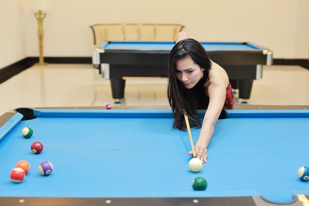 Foto mujer joven jugando con la pelota en la mesa