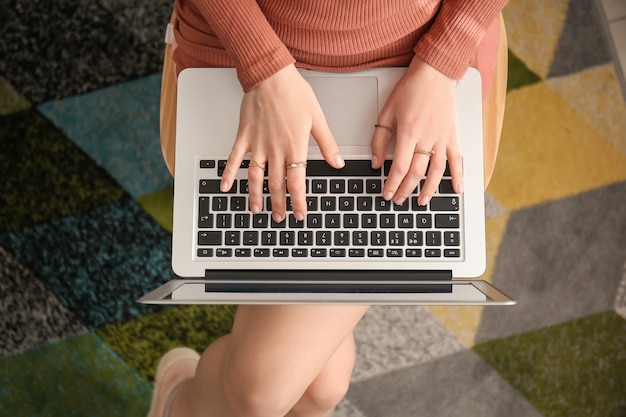 Mujer joven con laptop trabajando en casa, vista superior