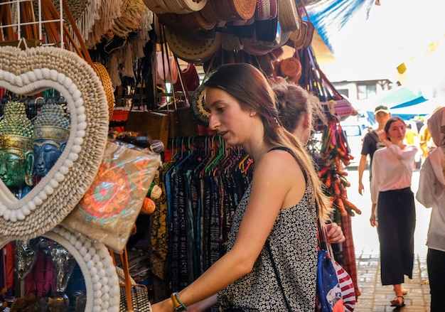 Mujer joven mirando un puesto en el mercado