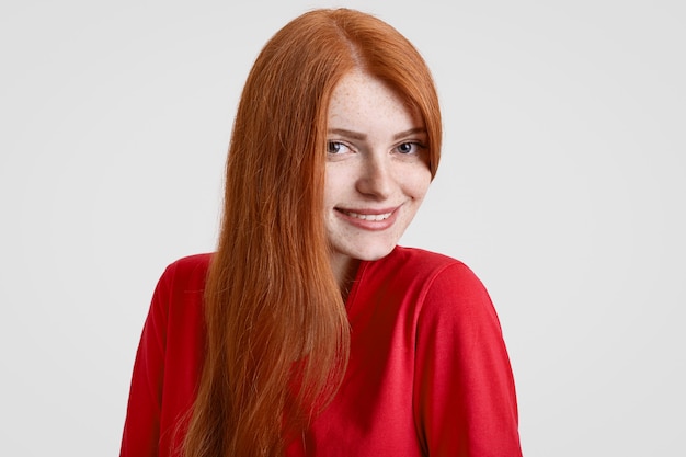 Mujer joven pecosa alegre con sonrisa suave toothy