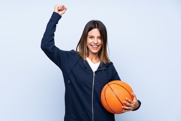 Mujer joven con pelota de baloncesto