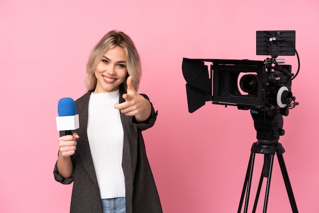 Mujer joven periodista sobre pared aislada