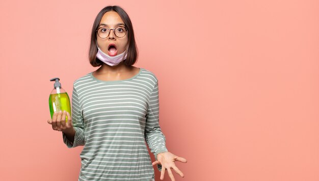 Mujer joven que se siente extremadamente conmocionada y sorprendida, ansiosa y en pánico, con una mirada estresada y horrorizada