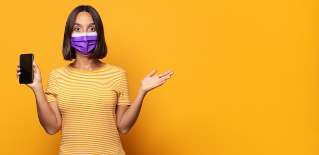 Foto mujer joven que se siente feliz, sorprendida y alegre, sonriendo con actitud positiva, dándose cuenta de una solución o idea