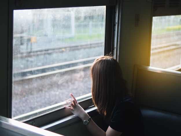 Mujer joven que viaja en el tren clásico, concepto de viaje