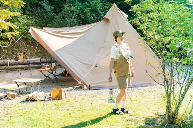 Mujer joven relajándose en un camping en buen día