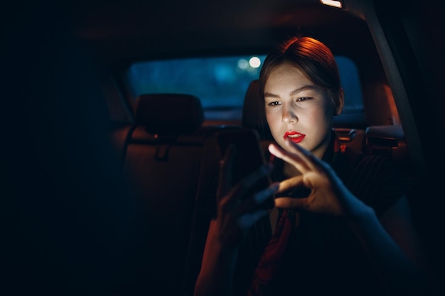 mujer joven, sentado, en, asiento trasero, de, vehículo automóvil, con, teléfono móvil, taxi, concepto