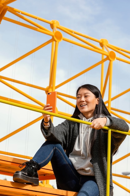 Mujer joven, sentado, en, sitio, construcción, puente