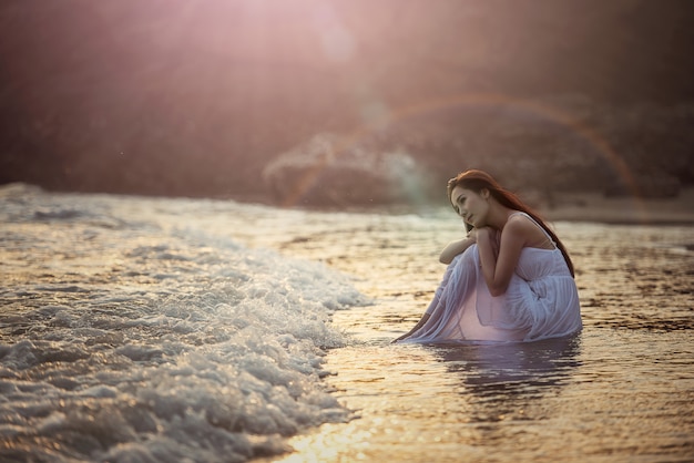 Mujer joven solitaria en la playa