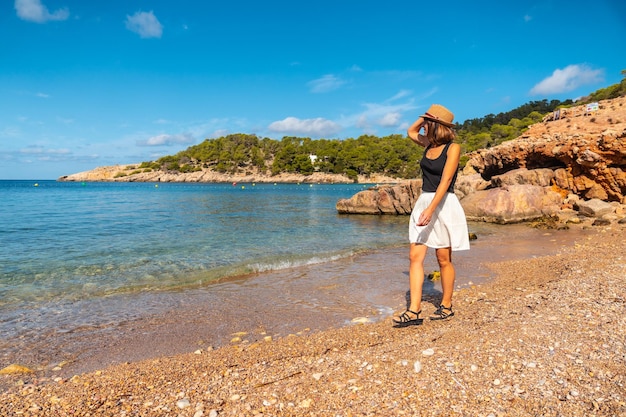 Una mujer joven con sombrero en Ibiza en la playa de Salada y Saladeta Balearic