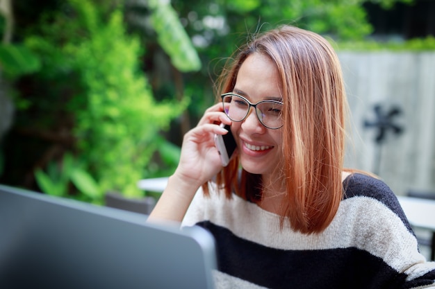 Mujer joven, sonriente, feliz, usar, smartphone