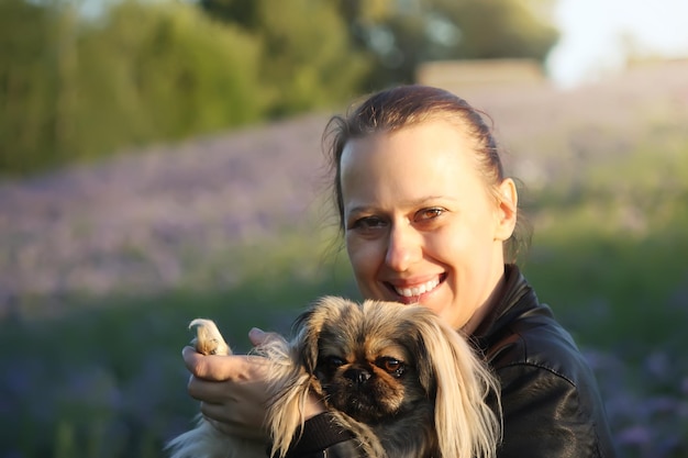 Mujer joven con su lindo perro al aire libre