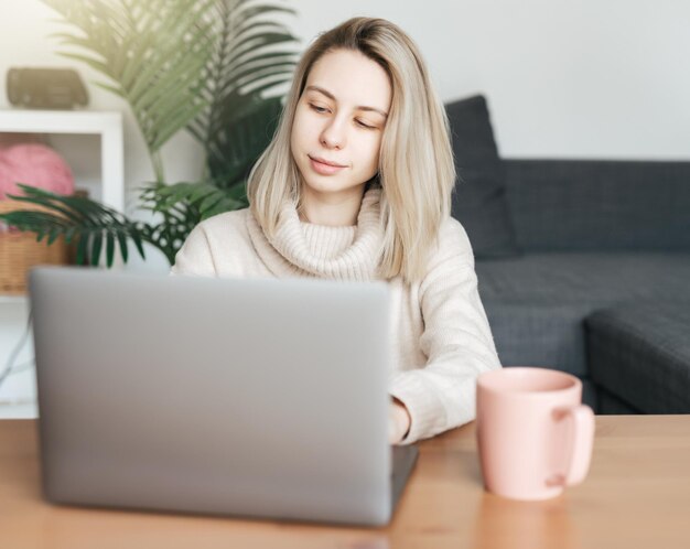 Mujer joven con tarjeta de crédito y usando una computadora portátil