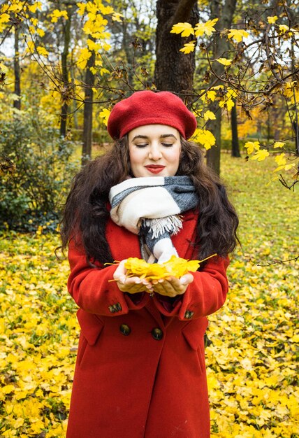 Foto mujer joven, tenencia, hojas de otoño