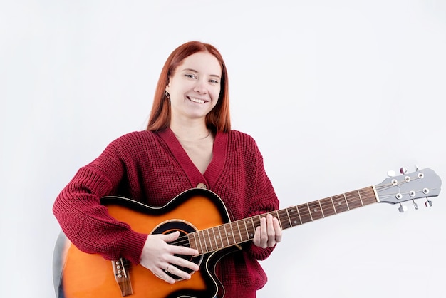 mujer joven, tocar la guitarra, aislado, blanco, plano de fondo