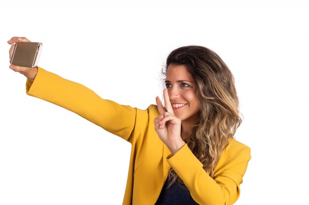 Mujer joven tomando un selfie con teléfono.