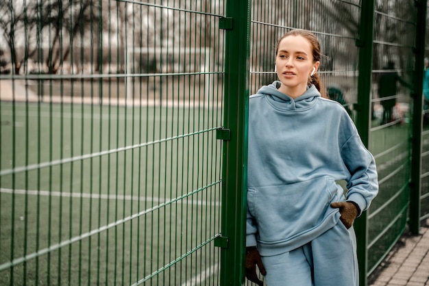 Mujer joven en traje deportivo haciendo ejercicio matutino al aire libre