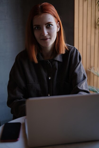 Mujer joven usando una computadora portátil en la oficina