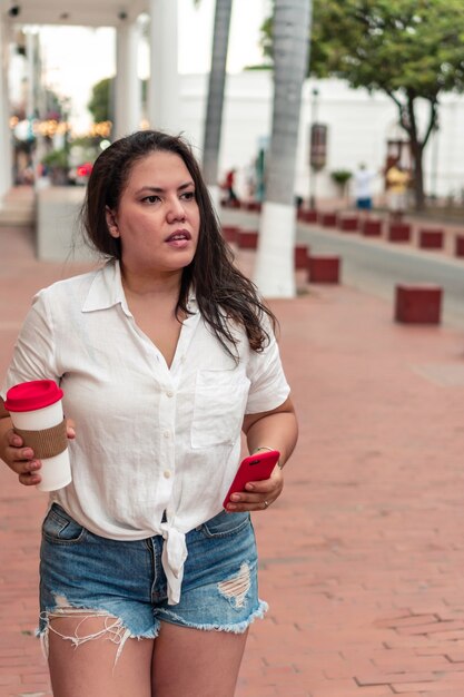 Foto mujer joven usando el teléfono en la calle