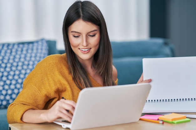 mujer joven, utilizar, computadora, en casa