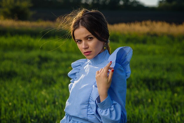 Mujer joven en vestido de rayas azul y blanco