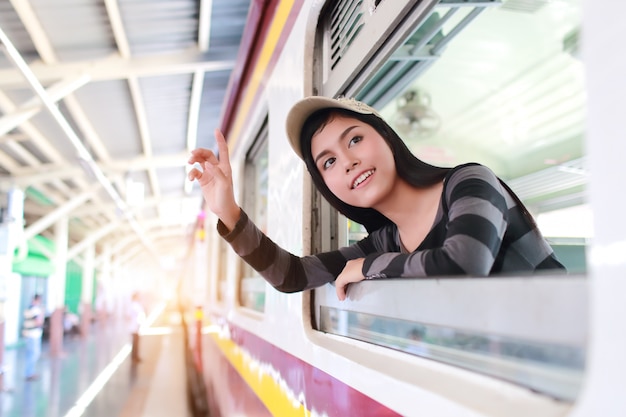 Mujer joven viajero mirando por la ventana