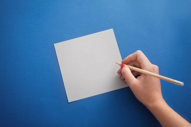 Foto mujer con lápiz escribiendo en un pedazo de papel