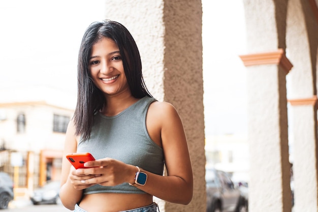 Mujer latinoamericana joven que usa smartphone