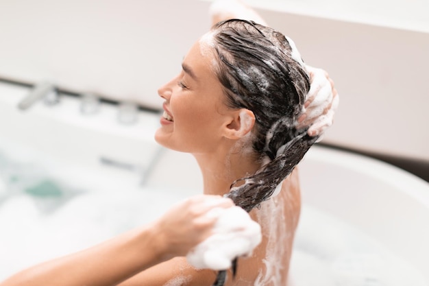 Foto mujer, lavado, cabeza, cuidado, para, pelo, sentado, en, bañera, interior