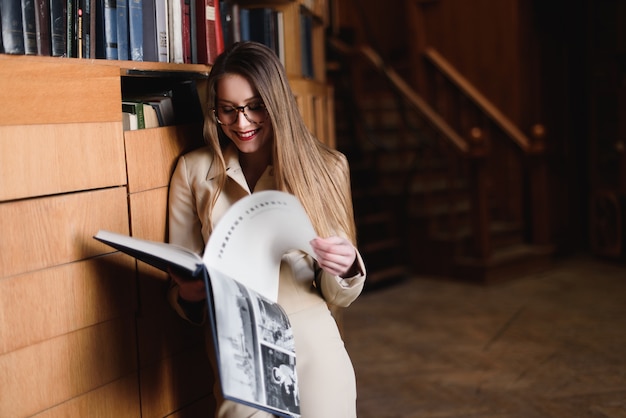 Mujer leyendo un libro de pie