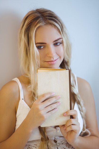 Foto mujer con un libro descansando en casa