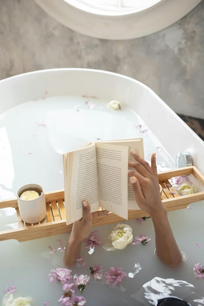 Foto mujer con libro y taza de café en el baño foto