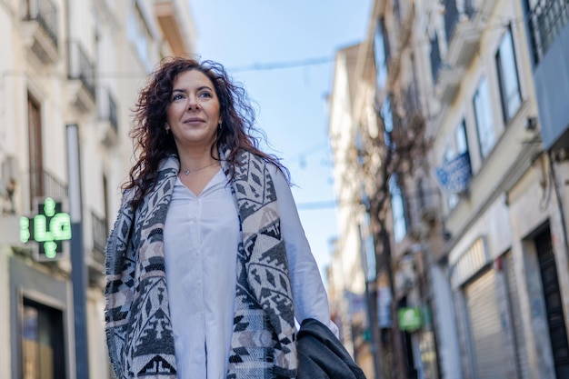 Mujer Madura Segura Caminando En La Ciudad. Mujer caminando en actitud positiva en la calle urbana