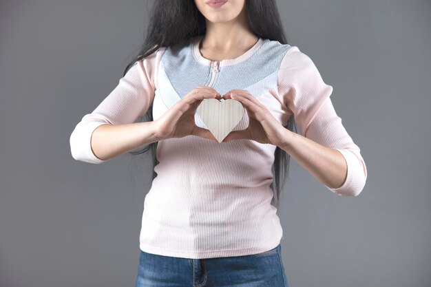 Mujer mano corazón de madera