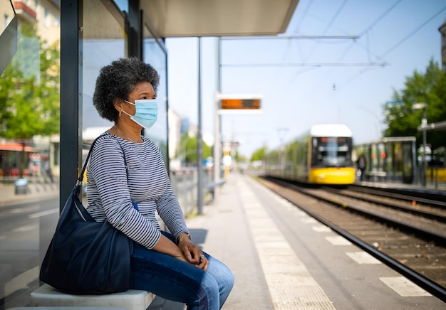 Mujer con máscara facial viajando en el tranvía de Berlín durante el brote de Covid-19