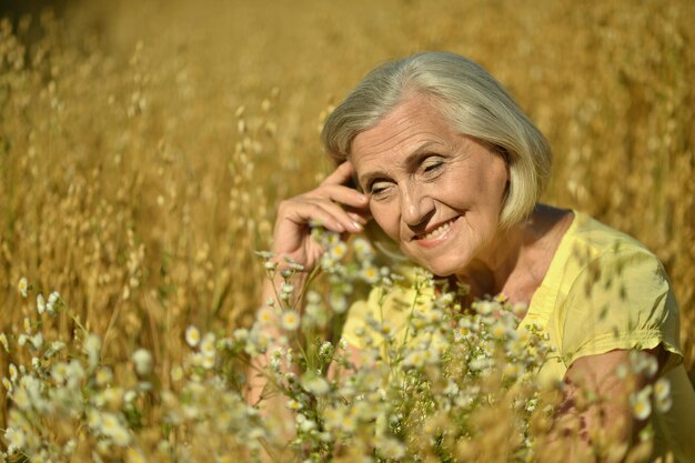 Mujer mayor feliz con flores