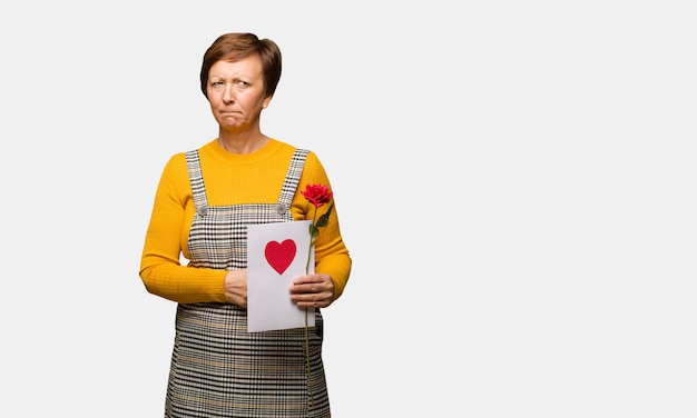 Foto mujer de mediana edad celebrando el día de san valentín pensando en una idea