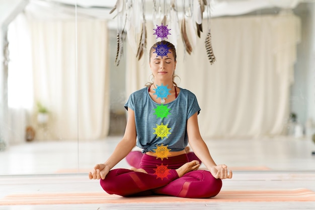 Foto mujer meditando en la postura del loto en el estudio de yoga