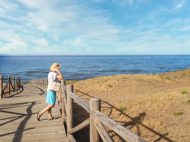 Mujer mirando la playa de Cabo Pino España