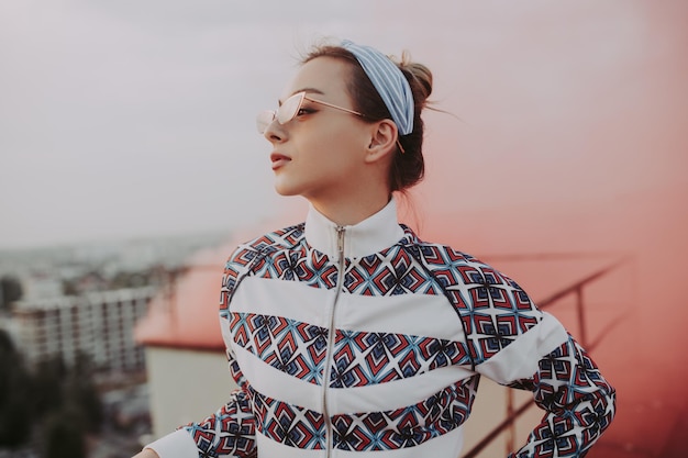 Mujer de moda contra el humo rosa en el techo