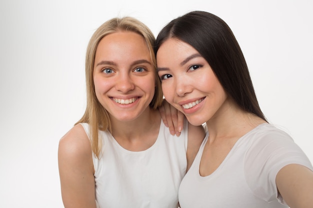 Mujer morena y rubia sonriendo