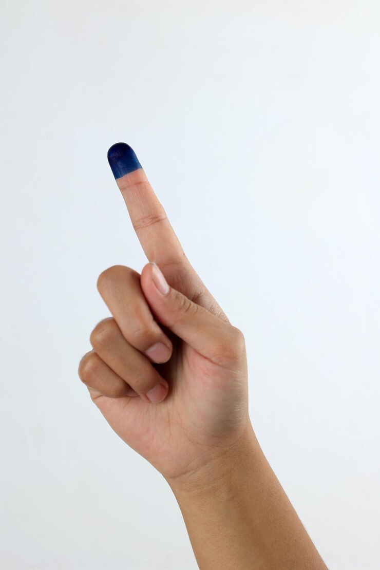 Foto mujer muestra la mano con tinta para el día de las elecciones indonesias o pemilu little finger jari tinta